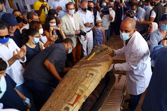 Staff members work near a newly discovered coffin on the site of the discovery in the Saqqara necropolis, Giza province, Egypt, on Oct. 3, 2020. (Xinhua/Ahmed Gomaa)