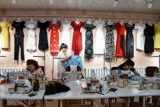 Workers make clothes at a clothing sewing cooperative at Daxi Village in Yuli County, northwest China's Xinjiang Uygur Autonomous Region, Sept. 4, 2020. (Xinhua/Ding Lei)