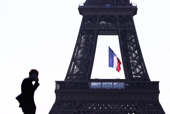 A man makes a phone call near the Eiffel Tower in Paris, France, May 15, 2020. (Xinhua/Gao Jing)