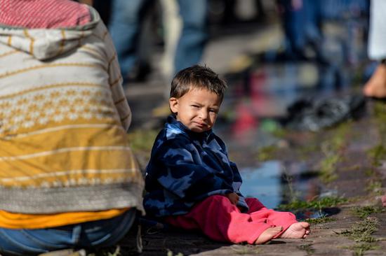 A child sits in a temporary transit center for migrants from Central America in Mexico City, capital of Mexico, Nov. 5, 2018. (Xinhua/Xin Yuewei)