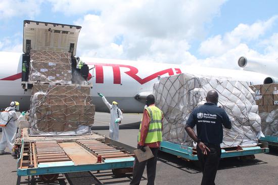 Workers disinfect medical supplies donated by the World Health Organization at Juba International Airport in Juba, South Sudan, on Sept. 4, 2020. (Photo by Gale Julius/Xinhua)