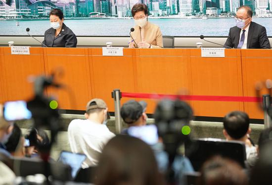 Chief Executive of the Hong Kong Special Administrative Region Carrie Lam (C) answers questions from the media during a press conference in Hong Kong, south China, Nov. 11, 2020. (Xinhua/Wang Shen)