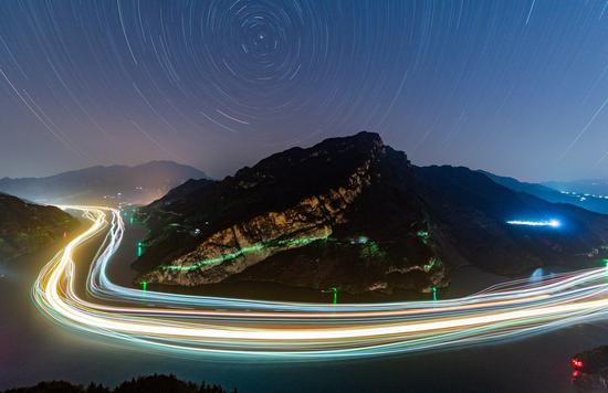 This long-time exposure photo shows the night scene of ships sailing in a section of the Xiling Gorge along the Yangtze River in Zigui County, central China's Hubei Province, Nov. 13, 2020. (Photo by Zheng Jiayu/Xinhua)