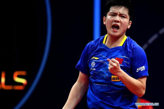 Fan Zhendong of China celebrates scoring during the men's singles semifinal match between Fan Zhendong of China and Jang Woojin of South Korea at 2020 ITTF finals in Zhengzhou, capital of central China's Henan Province, Nov. 21, 2020. (Xinhua/Li An)