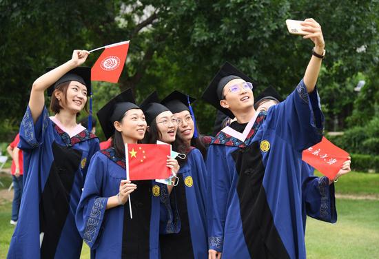 Graduates take a selfie after the commencement ceremony of Peking University in Beijing, capital of China, July 2, 2020. (Xinhua/Ren Chao)