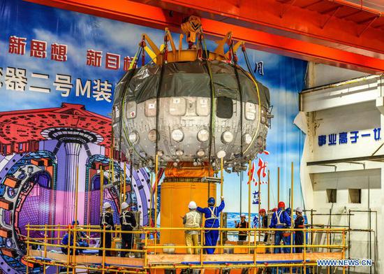 File photo taken on Sep. 28, 2019 shows staff members of China National Nuclear Corporation (CNNC) Southwestern Institute of Physics working at the installation site of the HL-2M Tokamak, China's new-generation 