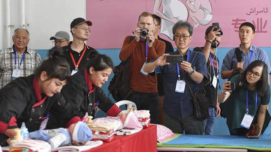 A group of reporters from 24 countries visit a vocational educational center in Moyu County, Xinjiang Uygur Autonomous Region, northwestern China, July 22, 2019. /Xinhua