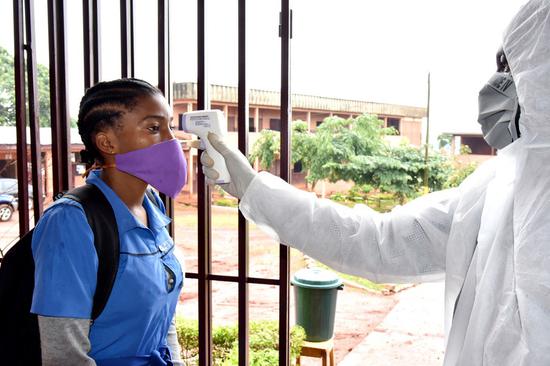 A student had her body temperature checked at a school in Yaounde, Cameroon, on June 1, 2020. (Xinhua)