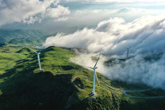 Aerial photo taken on Aug. 19, 2020 shows wind turbines in Jiucaiping scenic spot in southwest China's Guizhou Province. (Xinhua/Liu Xu)