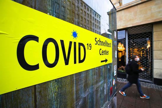 A sign leading to a Covid-19 test center is seen in Frankfurt, Germany, on Dec. 16, 2020. (Photo by Armando Babani/Xinhua)