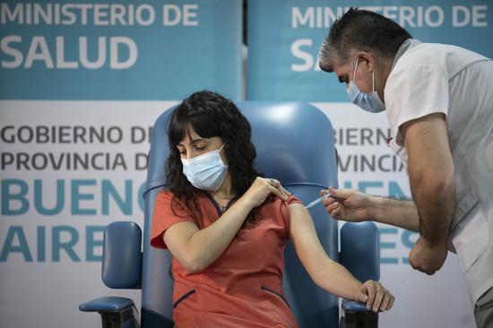 A medical worker receives a shot of the COVID-19 vaccine in Buenos Aires, Argentina, Dec. 29, 2020. (Photo by Martin Zabala/Xinhua)