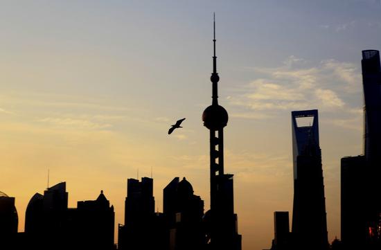 Skyscrapers are silhouetted at sunrise in this photo taken from the Bund in east China's Shanghai, Sept. 13, 2020. (Xinhua/Zhang Jiansong)