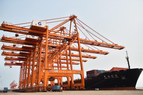 A cargo ship docks at Qinzhou Port in China-ASEAN Free Trade Area in Qinzhou, Guangxi Zhuang autonomous region, on July 11, 2020. (Photo/Xinhua)