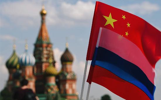 The national flags of China and Russia are seen on Red Square, Moscow.