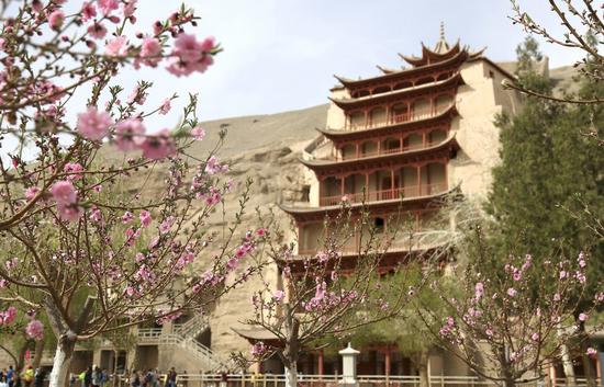 People visit the Mogao Grottoes, a world cultural heritage site, in Dunhuang, northwest China's Gansu Province, April 18, 2019. (Xinhua/Zhang Xiaoliang)