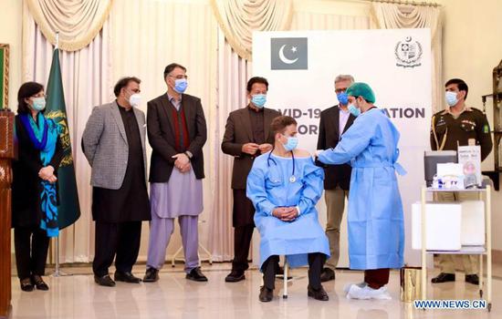 Photo released by Pakistan's Press Information Department (PID) shows a doctor receiving a shot of COVID-19 vaccine in Islamabad, capital of Pakistan, Feb. 2, 2021. Pakistan's Prime Minister Imran Khan launched COVID-19 vaccination drive with China-donated vaccines on Tuesday as part of the country's efforts to bring the pandemic under control. (PID/Handout via Xinhua)