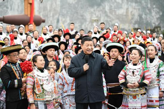 Chinese President Xi Jinping, also general secretary of the Communist Party of China Central Committee and chairman of the Central Military Commission, talks to villagers who are participating in festive activities, and extends his New Year's greetings to people of all ethnic groups across the country, on a public square of Huawu Village, Xinren Miao Township of Qianxi County, Bijie, southwest China's Guizhou Province, Feb. 3, 2021. Xi on Wednesday inspected southwest China's Guizhou Province ahead of the Spring Festival, or the Chinese Lunar New Year. (Xinhua/Xie Huanchi)