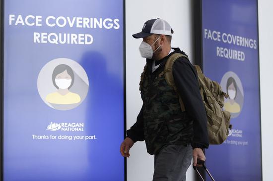 A traveler wearing a face mask is seen at Ronald Reagan Washington National Airport in Arlington, Virginia, the United States, Feb. 2, 2021. (Photo by Ting Shen/Xinhua)