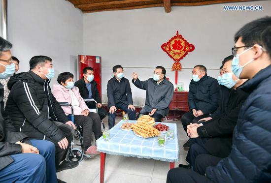 Chinese Premier Li Keqiang, also a member of the Standing Committee of the Political Bureau of the Communist Party of China Central Committee, visits villagers who have shaken off poverty in Wucun Village, Miaoqian Township, Xiaxian County in Yuncheng, north China's Shanxi Province, Feb. 7, 2021. Premier Li Keqiang on Sunday made an inspection tour in Yuncheng of north China's Shanxi Province ahead of the Spring Festival, or the Chinese Lunar New Year. (Xinhua/Yin Bogu)