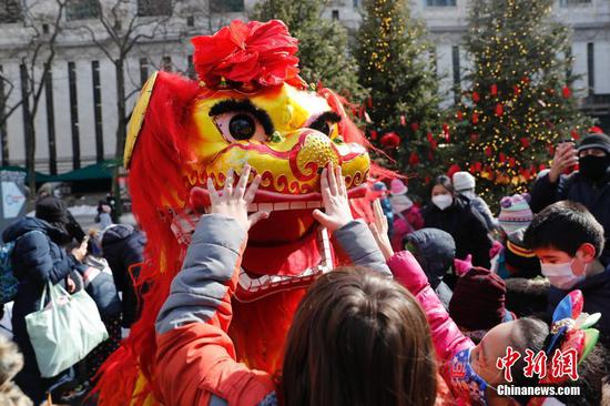 People watch lion dance performance in New York