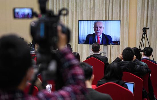 Dogu Perincek (on the screen), chairman of the Patriotic Party of Turkey, receives an online interview on the sidelines of an online briefing on the development of Xinjiang, Feb. 21, 2021. (Xinhua/Wang Fei)