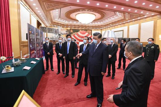 Chinese President Xi Jinping, also general secretary of the Communist Party of China (CPC) Central Committee and chairman of the Central Military Commission, visits an exhibition on the lunar samples brought back by the Chang'e-5 probe and China's lunar exploration achievements at the Great Hall of the People in Beijing, capital of China, Feb. 22, 2021.  (Xinhua/Li Xueren)
