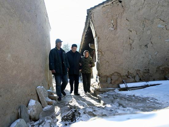 Xi Jinping (C), general secretary of the Communist Party of China (CPC) Central Committee and chairman of the CPC Central Military Commission, visits the family of Tang Zongxiu, an impoverished villager in the Luotuowan Village of Longquanguan Township, Fuping County, north China's Hebei Province. Xi made a tour to impoverished villages in Fuping County from Dec. 29 to 30, 2012. (Xinhua/Lan Hongguang)