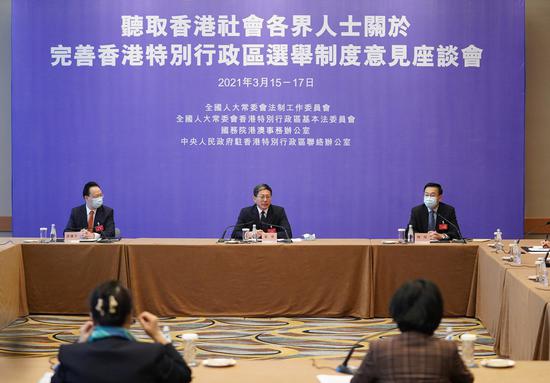 Zhang Yong (C), deputy head of the Commission for Legislative Affairs of the National People's Congress (NPC) Standing Committee, collects advice and suggestions on improving the electoral system of the Hong Kong Special Administrative Region (HKSAR) from the representatives of different sectors in Hong Kong, in Hong Kong, south China, March 15, 2021. (Xinhua/Lui Siu Wai)