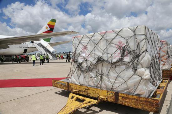 The vaccines are offloaded from a chartered Air Zimbabwe plane at Robert Gabriel Mugabe International Airport in Harare, Zimbabwe, on March 16, 2021. (Xinhua/Zhang Yuliang)
