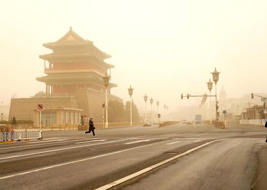 The Zhengyang Gate is seen shrouded in dust in Beijing, capital of China, March 15, 2021. Beijing was enveloped in yellow dust on Monday morning with visibility at less than 1 km, as the city's meteorological department issued a yellow warning for sandstorms, the third-most hazardous level. (Xinhua/Zhang Chenlin)