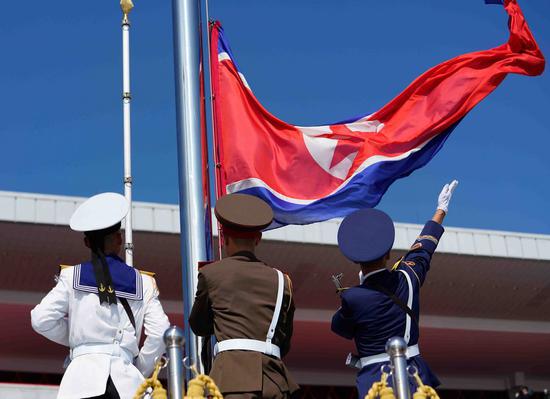 Soldiers raise the national flag before a parade to celebrate the 70th anniversary of the founding of the Democratic People's Republic of Korea (DPRK) in Pyongyang, DPRK, on Sept. 9, 2018. (Xinhua/Xing Guangli)