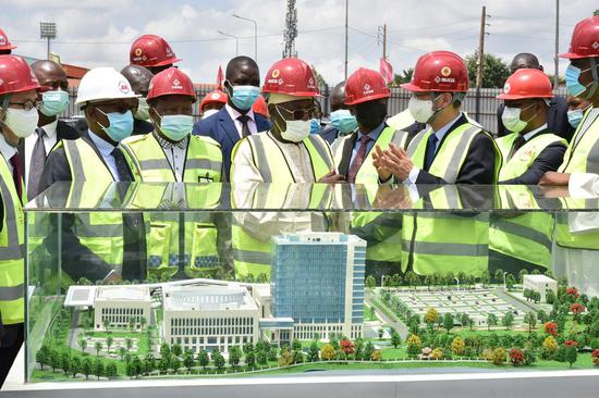 Cameroonian National Assembly House Speaker Cavaye Yeguie Djibril (C) and Minister of External Relations Lejeune Mbella Mbella (2nd L, Front), accompanied by Chinese Ambassador to Cameroon Wang Yingwu (Center R) visit the construction site of the country's new National Assembly building in Yaounde, Cameroon, on March 23, 2021. (Photo by Jean Pierre Kepseu/Xinhua)