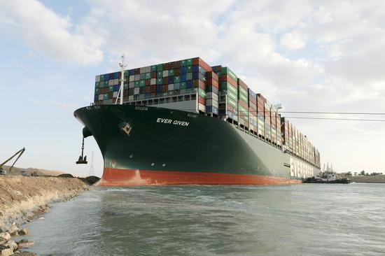 Rescue vessels work at the site of the stuck container ship Ever Given on the Suez Canal, Egypt, March 28, 2021. (Suez Canal Authority/Handout via Xinhua)