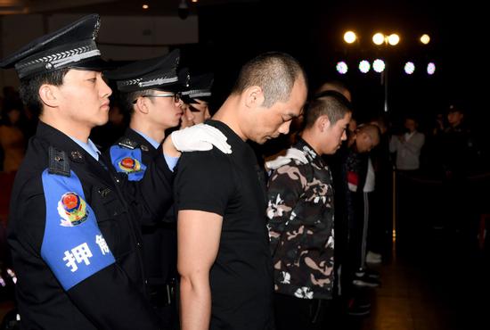 A court in Xi'an, Shaanxi province, sentences eight people for gang-related loan-sharking in March, 2019. (LIU XIAO/XINHUA)