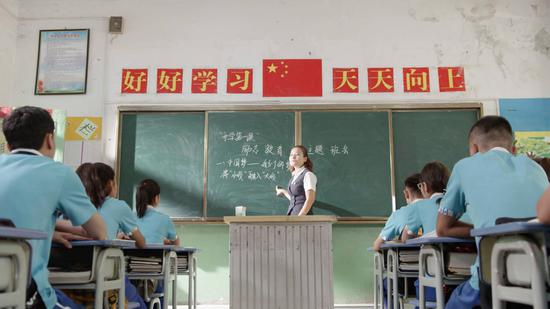 Guljahan Amat gives a history lecture at a middle school in Yecheng county, Xinjiang Uygur autonomous region. She said her students make her work 