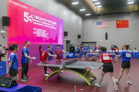 Players from China and the United States take part in a friendly match to commemorate the 50th anniversary of the Ping-Pong Diplomacy at the International Table Tennis Federation Museum in Shanghai, east China, April 10, 2021. (Xinhua/Wang Xiang)