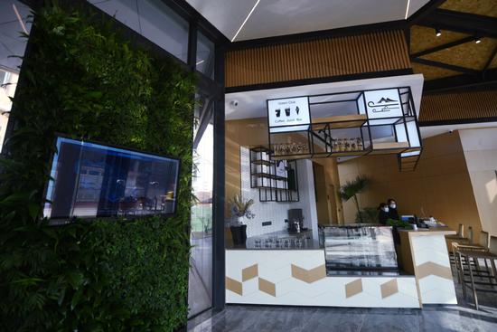 Receptionists at work at the 'green' lobby of a hotel in the Guashan Future Community in Hangzhou, Zhejiang province, on Jan 20. The hotel lobby is built on the green building design concept. (Photo by Long Wei/For China Daily)