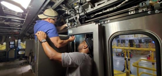 Undated photo shows employees work on the 7000-series passenger railcar prototype in China Railway Rolling Stock Corporation (CRRC) Sifang America Incorporated in Chicago, the United States. (Photo credit: CRRC Sifang America)