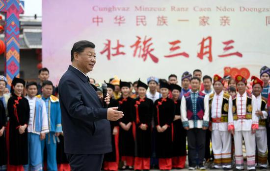 Chinese President Xi Jinping, also general secretary of the Communist Party of China Central Committee and chairman of the Central Military Commission, talks to people of different ethnic groups who are participating in festive activities outside the Anthropology Museum of Guangxi in the city of Nanning, south China's Guangxi Zhuang Autonomous Region, April 27, 2021. Xi made an inspection trip to south China's Guangxi Zhuang Autonomous Region from April 25 to April 27. (Xinhua/Xie Huanchi)