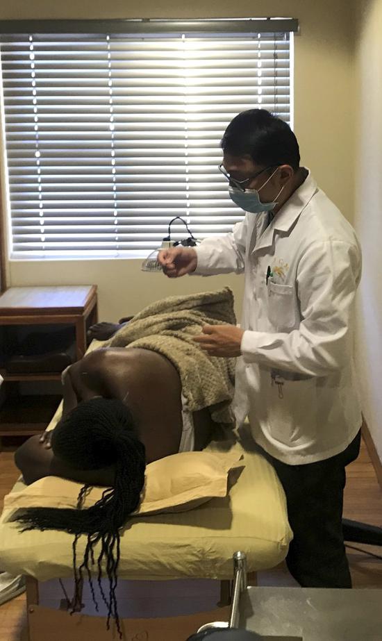Doctor Wang Peng, founder of the African Traditional Chinese Medicine Clinic, gives a patient acupuncture treatment at the clinic in Windhoek, Namibia, April 22, 2021. (Xinhua/Ndalimpinga Iita)