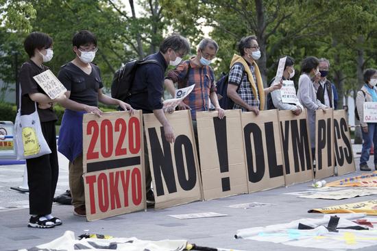 Opponents of the 2020 Olympics put their message across in a protest outside Tokyo's National Stadium on Sunday. (Photo/Agencies)