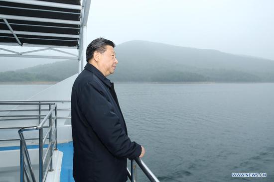 Chinese President Xi Jinping, also general secretary of the Communist Party of China Central Committee and chairman of the Central Military Commission, inspects the Danjiangkou Reservoir and listens to introductions to the construction, management and operation of the middle route of the South-to-North Water Diversion Project, and the ecological conservation of the water source region in Xichuan County, Nanyang, central China's Henan Province, May 13, 2021. (Xinhua/Ju Peng)