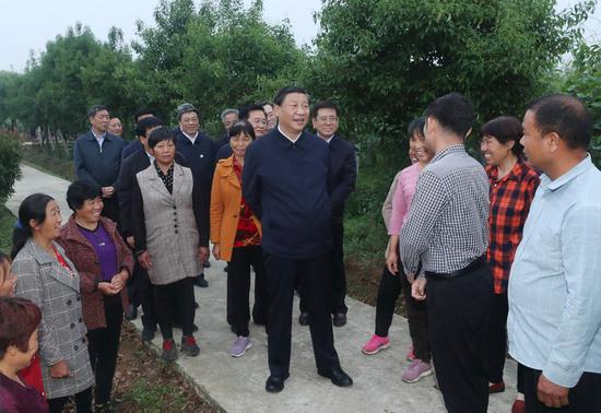 Chinese President Xi Jinping, also general secretary of the Communist Party of China Central Committee and chairman of the Central Military Commission, learns about the resettlement of people relocated because of the South-to-North Water Diversion Project, and measures to develop specialty industries and boost the incomes of resettled residents in Zouzhuang Village, Xichuan County, Nanyang, central China's Henan Province, May 13, 2021. (Xinhua/Wang Ye)