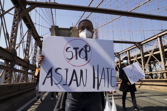 People march to protest against anti-Asian hate crimes on Brooklyn Bridge in New York, the United States, April 4, 2021. (Xinhua/Wang Ying)