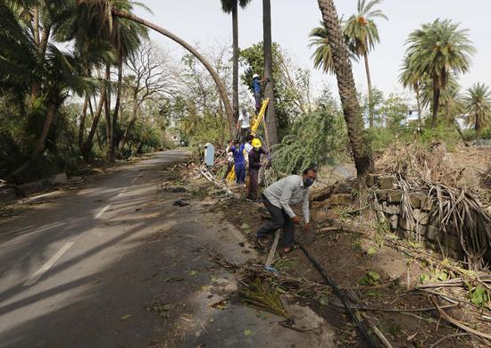 People try to restore electricity after Cyclone Tauktae hits Diu town, India, May 19, 2021. (Str/Xinhua)