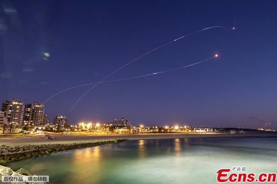 Streaks of light are seen as Israel's Iron Dome anti-missile system intercept rockets launched from the Gaza Strip towards Israel, as seen from Ashkelon May 19, 2021. (Photo/Agencies)