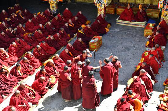 Monks attend the debate activity, a part of the award ceremony of the degree of Geshe Lharampa held in the Jokhang Temple in Lhasa, capital of southwest China's Tibet Autonomous Region, April 5, 2021. Geshe Lharampa, which means 