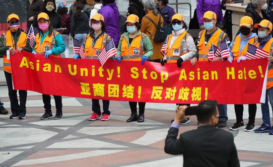 People holding a bilingual banner take part in a Stop Asian Hate rally in Oakland, San Francisco Bay Area, the United States, May 15, 2021. (Photo: Xinhua/Dong Xudong)