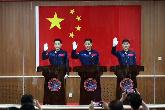 Chinese astronauts Nie Haisheng (C), Liu Boming (R) and Tang Hongbo meet the press at the Jiuquan Satellite Launch Center in northwest China, June 16, 2021. (Xinhua/Ju Zhenhua)