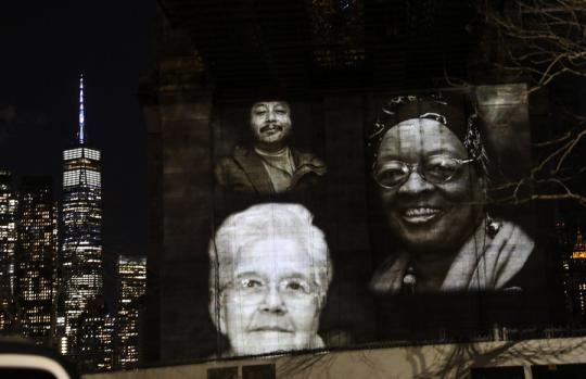 Images of New Yorkers lost to the COVID-19 pandemic are projected onto the Brooklyn Bridge in New York, the United States, March 14, 2021. (Xinhua/Wang Ying)